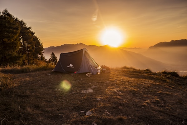 Mountain campground at sunrise with misty peaks